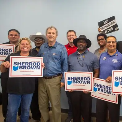 Photo of smiling constituents meeting with then-Senator Sherrod Brown